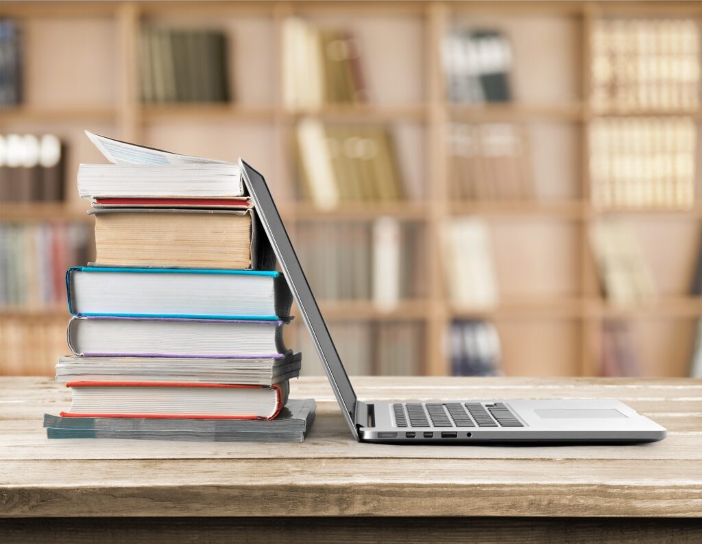 Laptop and books on the table.